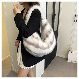 Chic oversized white faux fur hobo shoulder bag with grey spots shown on a model