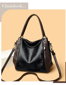 Detail of vintage tote bag showing textured leather finish and side zipper accents