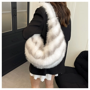 Close-up of a striped faux fur shoulder bag worn by a model in a modern interior