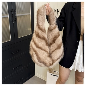Macro detail of striped faux fur tote bag with brown plush texture and integrated handle