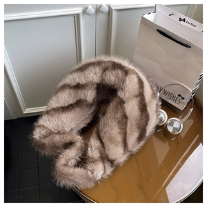 Detail of soft brown faux fur texture and striped fluffy pattern for winter handbag