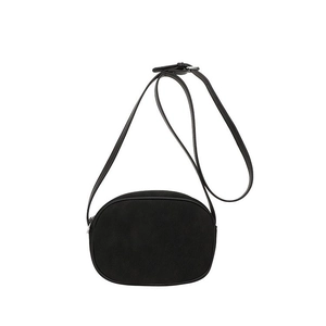 Minimalist black oval crossbody bag with adjustable strap and smooth matte finish