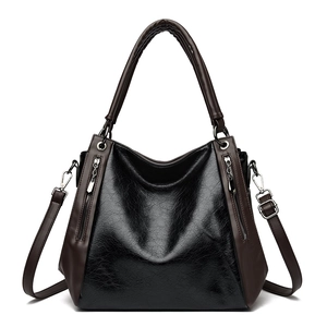 Large capacity tote bag in black and brown oil-wax leather with adjustable shoulder strap