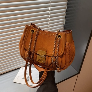 Brown suede shoulder bag featuring vertical pleated design and vintage gold chain strap