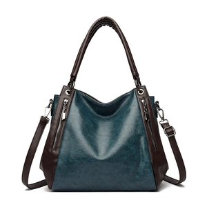 Large dark lake blue vintage leather tote bag with brown handles and crossbody strap