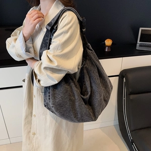 Large denim hobo shoulder bag with wide strap for versatile daily commuting style