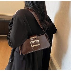 Detailed back view of deep brown glossy underarm bag with silver square buckle