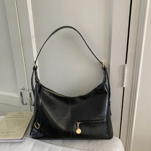Retro black leather underarm bag with glossy crinkle texture and gold hardware details