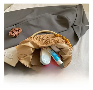 Detail shot of woven straw bag interior with wooden bead handles and ample storage