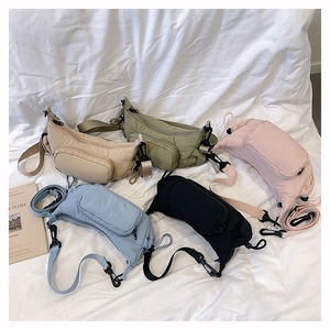 Close-up of quilted nylon crossbody bags in five colors with adjustable straps and zip pockets