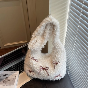 White faux fur shoulder bag with burgundy bows and gold heart charms for winter fashion