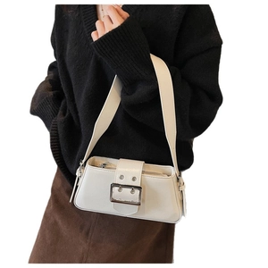 Minimalist white PU leather baguette bag with large silver buckle shown on shoulder