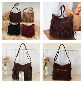 Detail of bohemian suede crossbody bag with long fringes and metal zipper on back