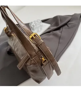Detail of brown quilted hobo bag featuring vintage oil wax texture and gold hardware