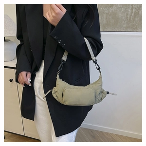 Close-up of a khaki nylon crescent bag with multi-pocket design and adjustable strap