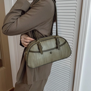 Chic dark green woven shoulder bag with golden hardware for stylish daily commute use