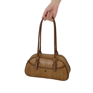 Brown woven texture tote bag with adjustable long handles and gold metal buckles