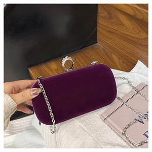 Detail of purple velvet evening bag with crystal ring clasp and silver chain strap