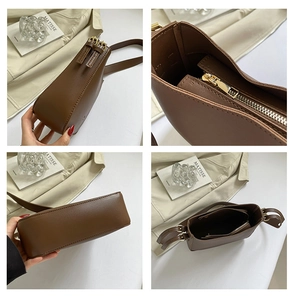Détails du sac bandoulière en cuir marron avec fermeture éclair dorée et compartiments