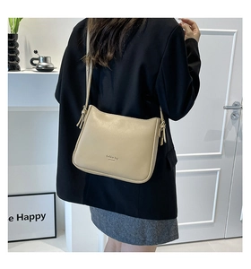 Détail du sac bandoulière carré en cuir PU beige avec bandoulière nouée et logo
