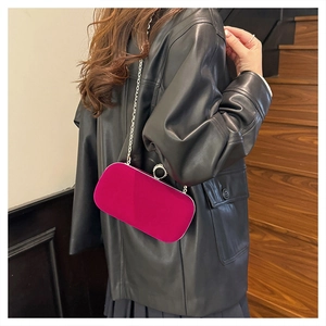 Fuchsia velvet evening clutch featuring a rhinestone clasp and silver chain strap