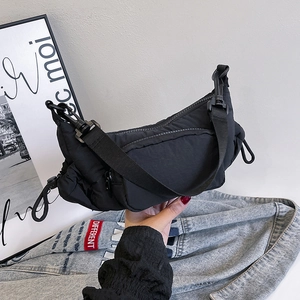 Puffy black cloud bag with adjustable wide strap for casual crossbody or shoulder wear