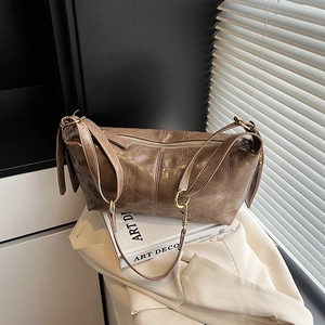 Brown quilted crossbody hobo bag with diamond lattice pattern and gold hardware