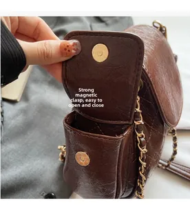Close-up of brown quilted bag showing a strong magnetic buckle for easy opening