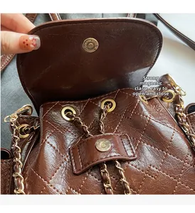 Detail of strong magnetic snap on brown quilted leather bag for easy opening