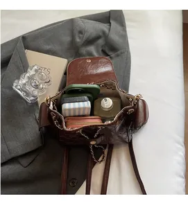 Detailed interior of quilted leather bag showing large capacity for essentials and gold chain