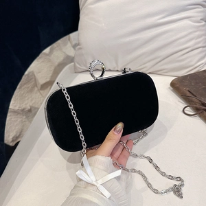 Elegant black velvet evening clutch with silver metal trim and diamond circular ring clasp