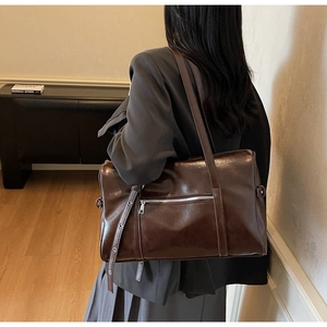 Detail of dark brown vintage Boston bag showing sleek glossy leather and side silver zipper