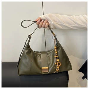 Deep olive green leather underarm bag featuring a vintage wooden beaded tassel detail