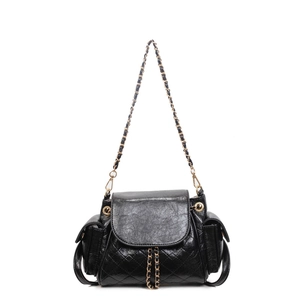 Black quilted faux leather shoulder bag with gold chain straps and side utility pockets