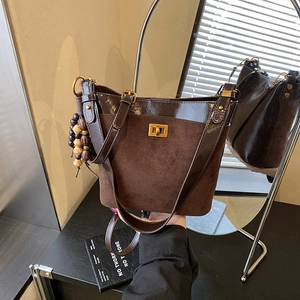 Large vintage coffee bucket bag with gold twist lock and beaded tassel for daily commuting