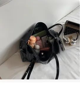 Top view of spacious black leather Boston bag interior showing large storage capacity