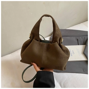 Close-up of a dark brown suede pleated cloud bag with soft textures and stylish shoulder strap