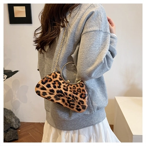 Leopard print box bag featuring a gold metal ring handle and elegant chain strap detail