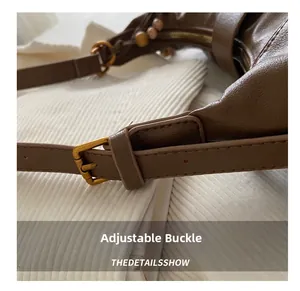 Macro shot of dark brown leather strap with adjustable vintage gold metal buckle