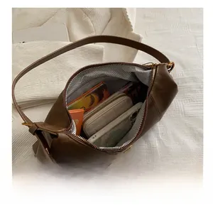 Large capacity brown leather bag showing spacious interior with herringbone lining