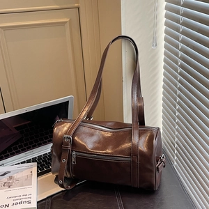 Deep brown Boston barrel bag in glossy PU leather with adjustable straps for daily commute