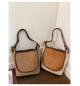 Detail of wool-like plush and matte leather bucket bags in brown and beige colors