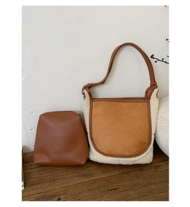 Detail view of dual-material tote bag with lambswool texture and inner pouch