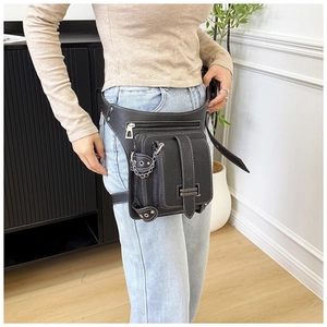 Detail of black leather waist leg bag with contrast stitching and punk chain accents