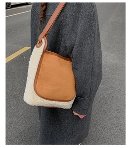 Detail of contrast stitch tote with brown suede and white sherpa fleece material