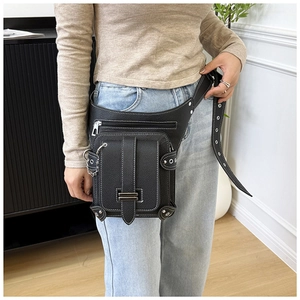 Detail of black motorcycle waist bag with white contrast stitching and metallic chain strap