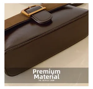 Detail of dark brown leather handbag featuring mixed textures and golden square buckle