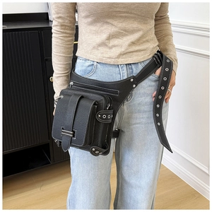 Close-up of black lychee leather waist leg bag featuring white stitching and metal eyelets