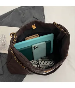 Top view of spacious brown quilted tote interior showing ample storage for gadgets and wallet
