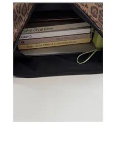 Detailed interior view of a leopard print tote bag showing large storage capacity